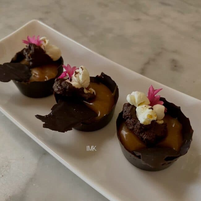 Chocolate caramel tartlets with edible petals