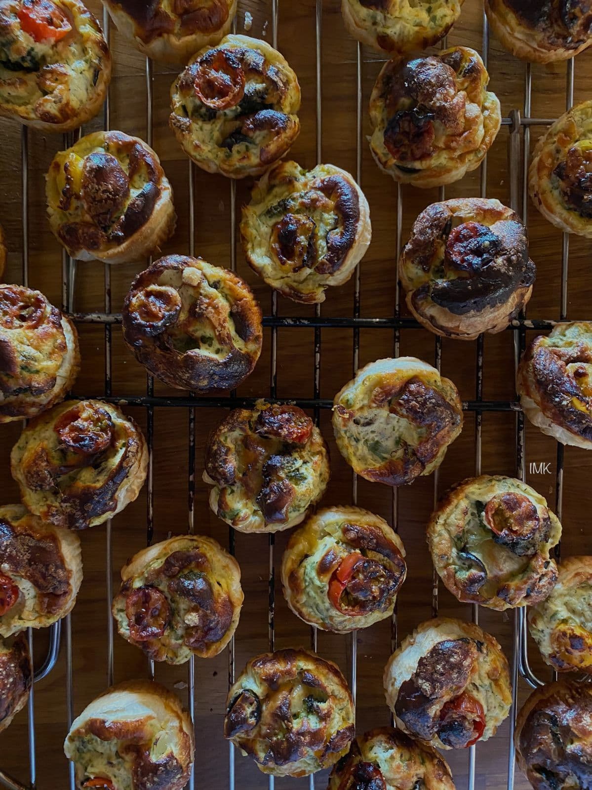 Oven-baked savory mini quiches on cooling rack
