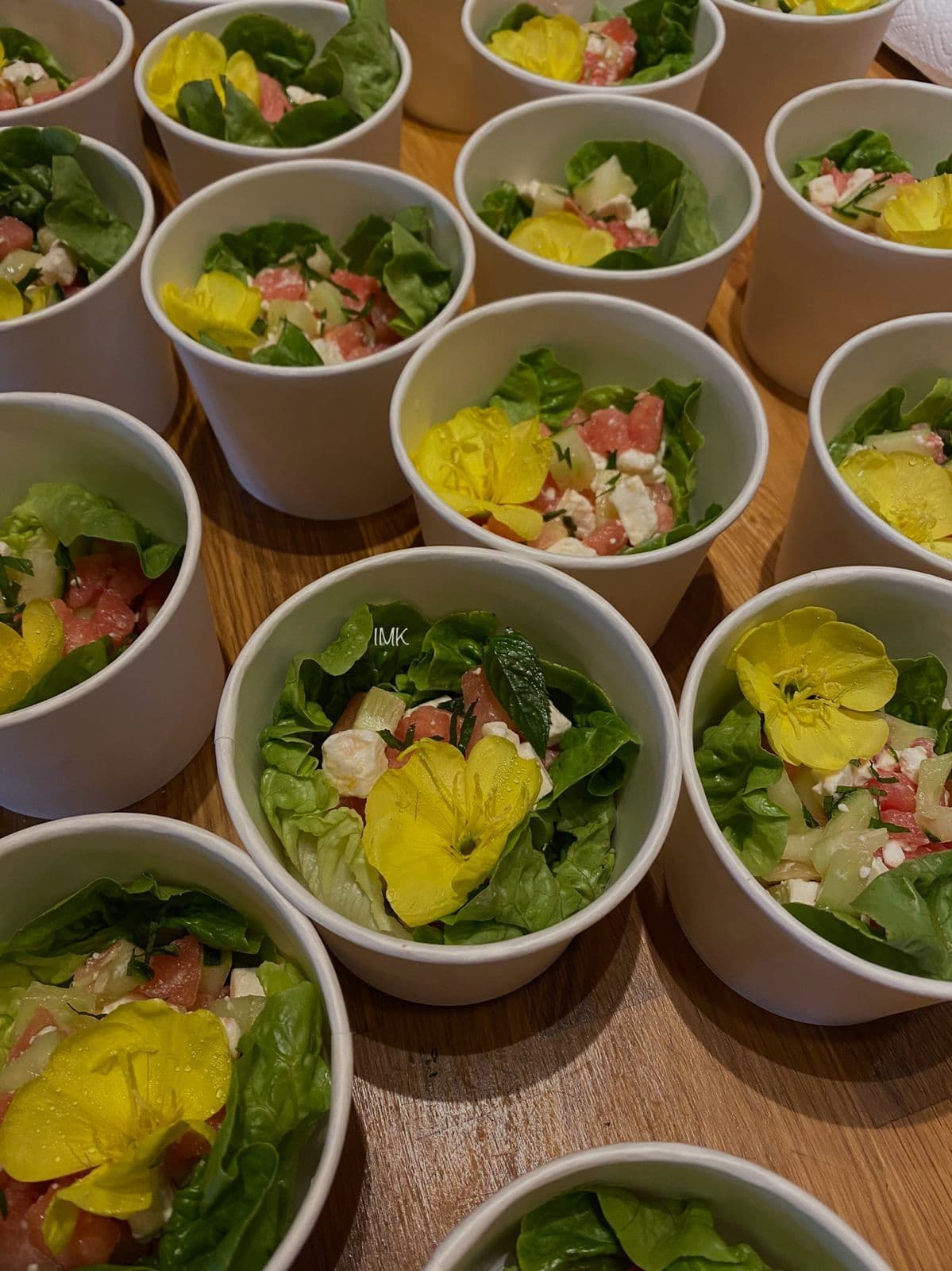 Fresh salad bowls with yellow pansy flowers