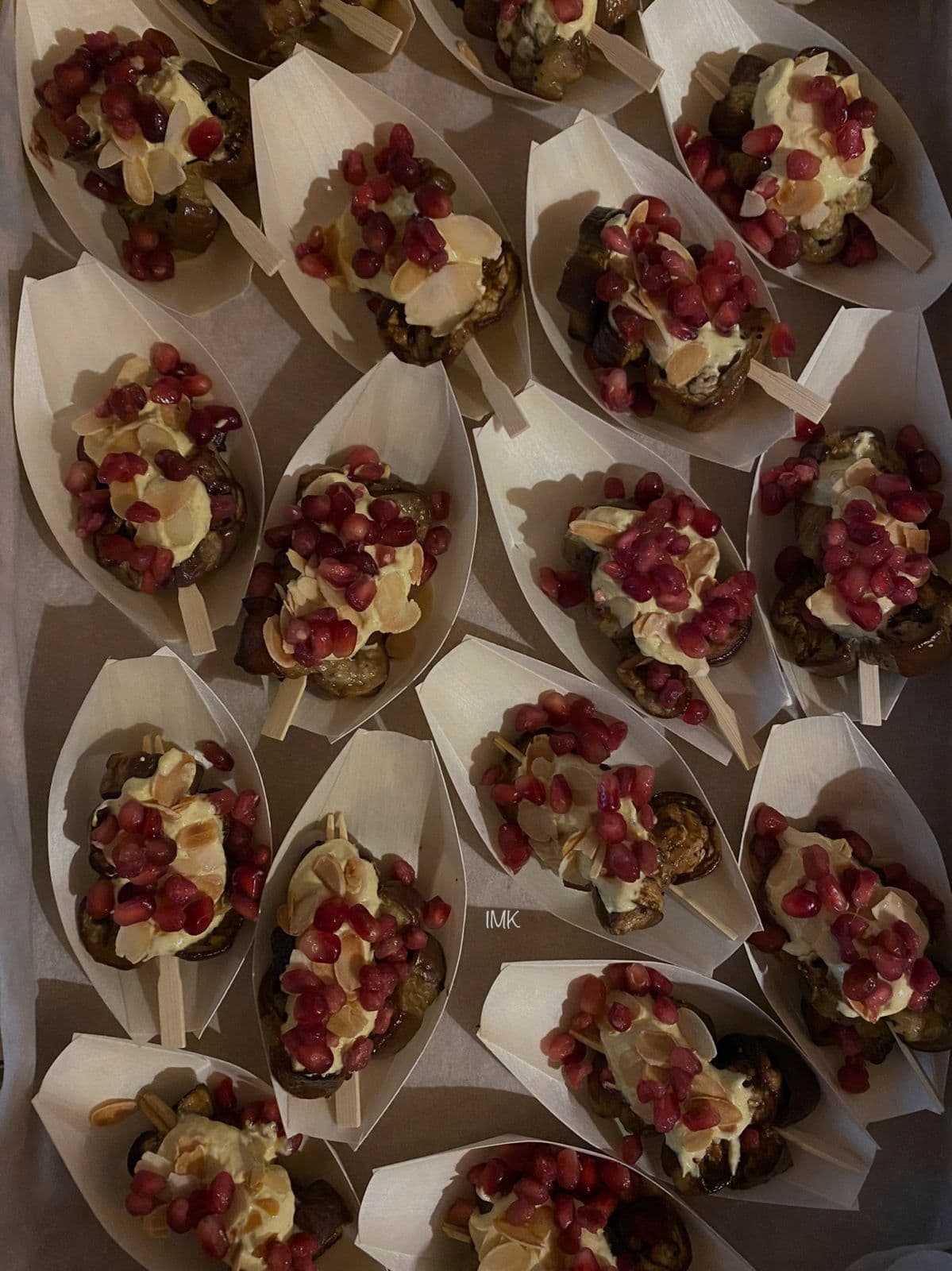Wooden boat skewers with pomegranate seeds