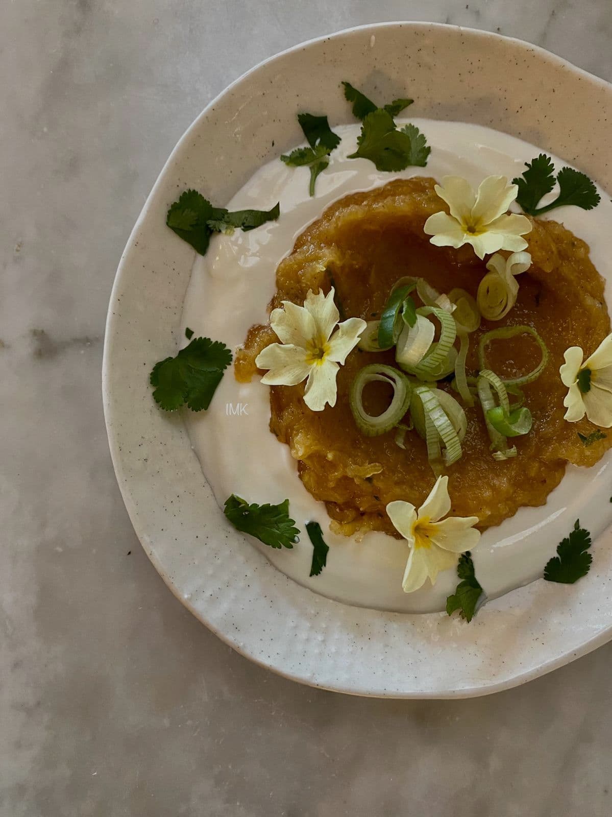 Whipped cream dessert with edible flowers